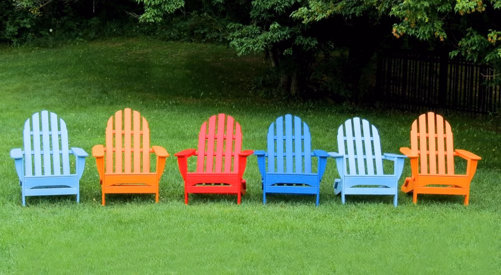 colorful-adirondack-chairs-on-lawn-with-greenery